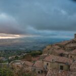 Vista panoramica delle colline toscane dal villaggio medievale, circondato da natura e storia.